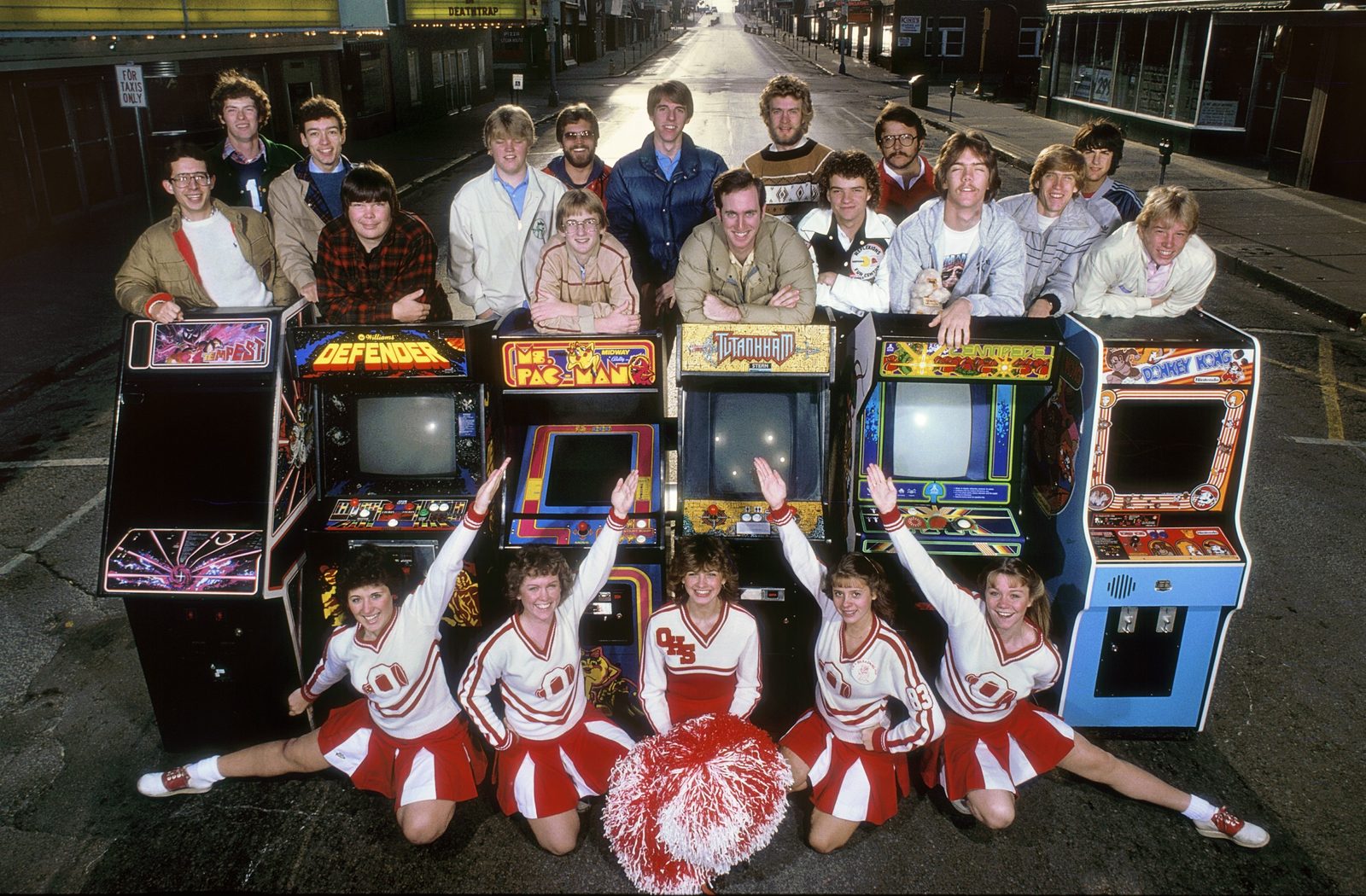 LIFE magazine's 1982 group portrait of top video game players with their arcade cabinets on a street in Ottumwa, Iowa, with cheerleaders in front; Steve Sanders is among the players